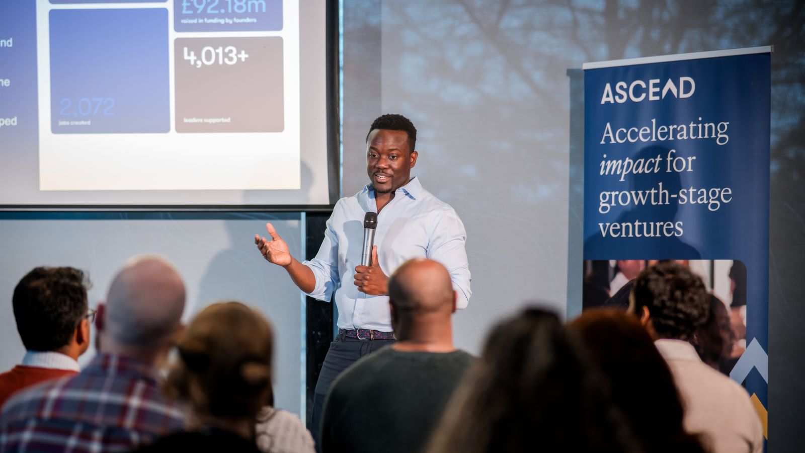 Cecil Adjalo presenting Foundervine impact figures to an audience at Ascend